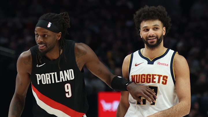 Feb 20, 2026; Portland, Oregon, USA;  Portland Trail Blazers forward Jerami Grant (9) talks to Denver Nuggets guard Jamal Murray (27) during first half at Moda Center.