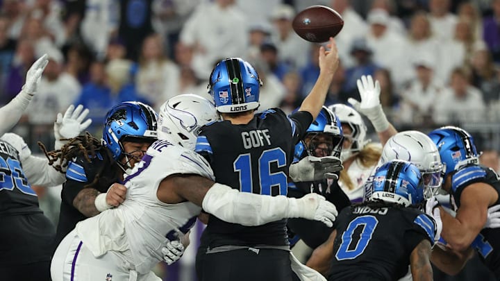 Minnesota Vikings defensive tackle Javon Hargrave (97) tackles Detroit Lions quarterback Jared Goff (16) 