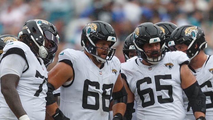 Sep 15, 2024; Jacksonville, Florida, USA;  Jacksonville Jaguars offensive line Anton Harrison (77), offensive line Brandon Scherff (68), and offensive line Mitch Morse (65) wait to line up for the drive against the Cleveland Browns during the third quarter at EverBank Stadium. Mandatory Credit: Morgan Tencza-Imagn Images