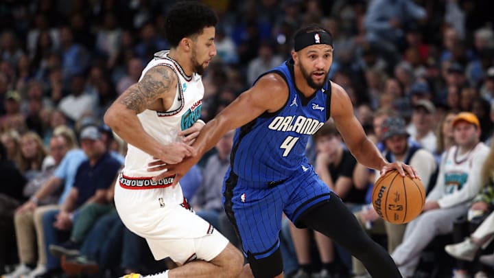 Orlando Magic guard Jalen Suggs (4) drives to the basket as Memphis Grizzlies guard Scotty Pippen Jr. (1) defends.  