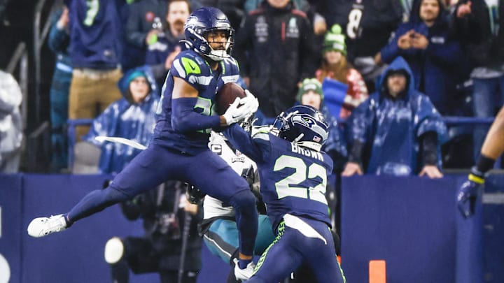 Dec 18, 2023; Seattle, Washington, USA; Seattle Seahawks safety Julian Love (20) intercepts a pass against the Philadelphia Eagles during the fourth quarter at Lumen Field.
