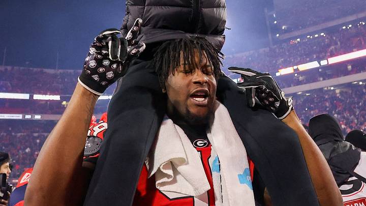 Nov 29, 2024; Athens, Georgia, USA; Georgia Bulldogs offensive lineman Bo Hughley (59) holds up Andrew Smart, son of head coach Kirby Smart, after a victory over the Georgia Tech Yellow Jackets in eight overtimes at Sanford Stadium. Nov 29, 2024; Athens, Georgia, USA; Georgia Bulldogs offensive lineman Bo Hughley (59) holds up Andrew Smart, son of head coach Kirby Smart, after a victory over the Georgia Tech Yellow Jackets in eight overtimes at Sanford Stadium.