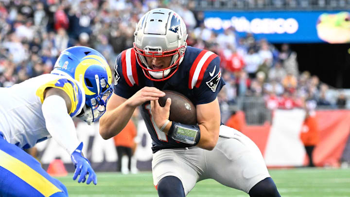 Nov 17, 2024; Foxborough, Massachusetts, USA; New England Patriots quarterback Drake Maye (10) prepares to take a hit from Los Angeles Rams safety Kamren Curl (3) during the second half at Gillette Stadium. Mandatory Credit: Eric Canha-Imagn Images