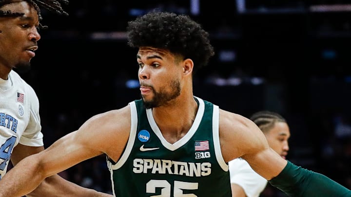 Michigan State forward Malik Hall (25) dribbles against North Carolina forward Jae'Lyn Withers (24) during the first half of the NCAA tournament West Region second round at Spectrum Center in Charlotte, N.C. on Saturday, March 23, 2024. Michigan State forward Malik Hall (25) dribbles against North Carolina forward Jae'Lyn Withers (24) during the first half of the NCAA tournament West Region second round at Spectrum Center in Charlotte, N.C. on Saturday, March 23, 2024.