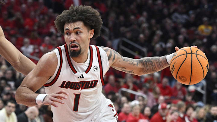 Mar 1, 2025; Louisville, Kentucky, USA;  Louisville Cardinals guard J'Vonne Hadley (1) dribbles past Pittsburgh Panthers forward Cameron Corhen (2) during the second half at KFC Yum! Center. Louisville defeated Pittsburgh 79-68. Mandatory Credit: Jamie Rhodes-Imagn Images