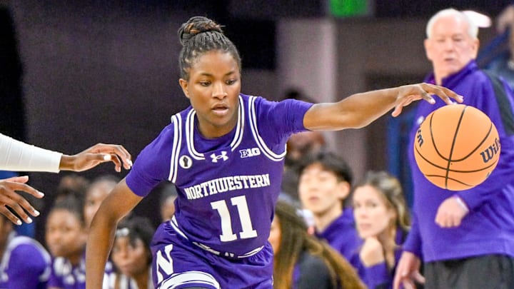 Nov 15, 2023; South Bend, Indiana, USA; Northwestern Wildcats guard Hailey Weaver (11) dribbles as Notre Dame Fighting Irish guard KK Bransford (14) defends in the second half at the Purcell Pavilion.