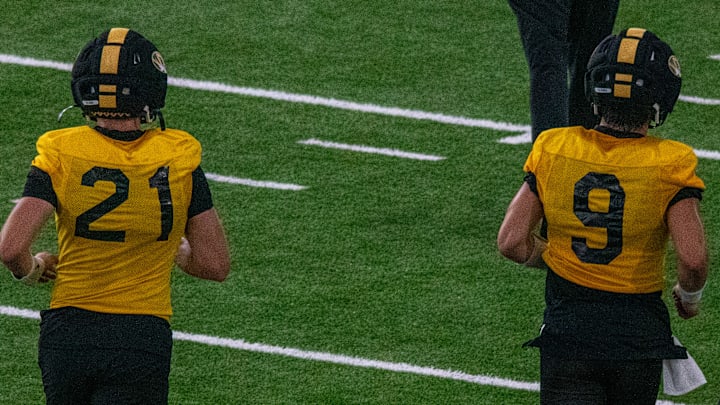 Aug 18, 2025; Columbia, MO, USA; Missouri Tigers quarterbacks Sam Horn (21) and Beau Pribula (9) jog to a drill at a fall camp practice at Stephens In Aug 18, 2025; Columbia, MO, USA; Missouri Tigers quarterbacks Sam Horn (21) and Beau Pribula (9) jog to a drill at a fall camp practice at Stephens In