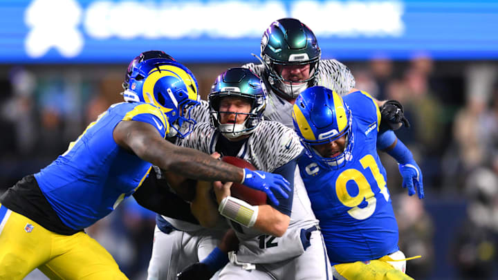 Dec 18, 2025; Seattle, Washington, USA; Los Angeles Rams linebacker Jared Verse (8) and defensive end Kobie Turner (91) sack Seattle Seahawks quarterback Sam Darnold (14) in the second half at Lumen Field. Mandatory Credit: Steven Bisig-Imagn Images