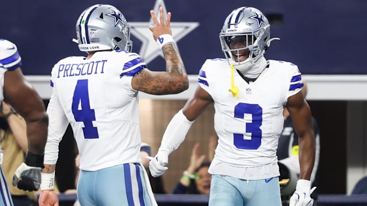 Dallas Cowboys wide receiver George Pickens celebrates a touchdown with quarterback Dak Prescott.