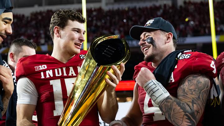 Jan 19, 2026; Miami Gardens, FL, USA; Indiana Hoosiers quarterback Fernando Mendoza (16), wide receiver Elijah Sarratt (13) and linebacker Aiden Fisher (4) celebrate with the trophy after defeating the Miami Hurricanes in the College Football Playoff National Championship game at Hard Rock Stadium. Mandatory Credit: Mark J. Rebilas-Imagn Images Jan 19, 2026; Miami Gardens, FL, USA; Indiana Hoosiers quarterback Fernando Mendoza (16), wide receiver Elijah Sarratt (13) and linebacker Aiden Fisher (4) celebrate with the trophy after defeating the Miami Hurricanes in the College Football Playoff National Championship game at Hard Rock Stadium. Mandatory Credit: Mark J. Rebilas-Imagn Images