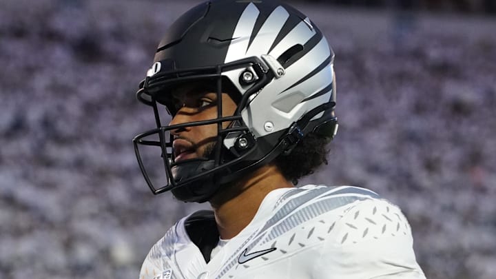 Sep 27, 2025; University Park, Pennsylvania, USA; Oregon Ducks quarterback Dante Moore (5) warms up before a game against the Penn State Nittany Lions at Beaver Stadium. Mandatory Credit: James Lang-Imagn Images