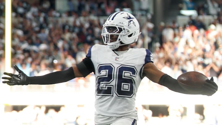 Dallas Cowboys cornerback Daron Bland returns an interception for a touchdown against the Washington Commanders