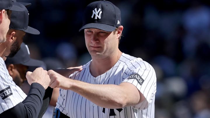Mar 27, 2025; Bronx, New York, USA; New York Yankees injured starting pitcher Gerrit Cole (45) fist bumps teammates during introductions before an opening day game against the Milwaukee Brewers at Yankee Stadium. Mandatory Credit: Brad Penner-Imagn Images