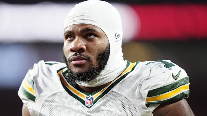Green Bay Packers defensive end Micah Parsons walks off the field with help from medical personnel.