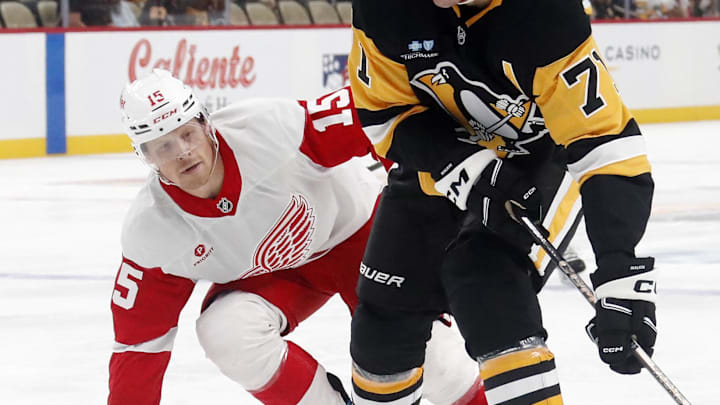Oct 1, 2024; Pittsburgh, Pennsylvania, USA;  Pittsburgh Penguins center Evgeni Malkin (71) skates with the puck ahead of Detroit Red Wings center Sheldon Dries (15) during the first period at PPG Paints Arena. Mandatory Credit: Charles LeClaire-Imagn Images
