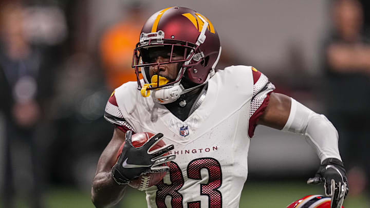 Oct 15, 2023; Atlanta, Georgia, USA; Washington Commanders wide receiver Jamison Crowder (83) is tackled by Atlanta Falcons cornerback Tre Flowers (33) after a long punt return during the first half at Mercedes-Benz Stadium. Mandatory Credit: Dale Zanine-Imagn Images
