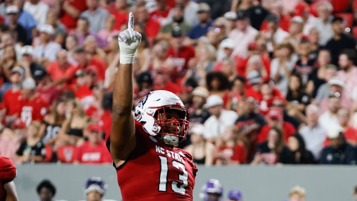 Aug 29, 2024; Raleigh, North Carolina, USA; North Carolina State Wolfpack defensive end Travali Price (13) celebrates during the first half of the game against Western Carolina Catamounts at Carter-Finley Stadium. Mandatory Credit: Jaylynn Nash-Imagn Images Aug 29, 2024; Raleigh, North Carolina, USA; North Carolina State Wolfpack defensive end Travali Price (13) celebrates during the first half of the game against Western Carolina Catamounts at Carter-Finley Stadium. Mandatory Credit: Jaylynn Nash-Imagn Images