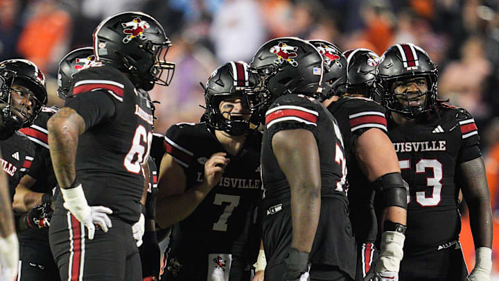 Louisville Cardinals quarterback Miller Moss (7) huddles with his offensive line late in the fourth quarter against Clemson during the Cards 20-19 loss at L&N Stadium in Louisville, Kentucky Friday, Nov. 14, 2025.
