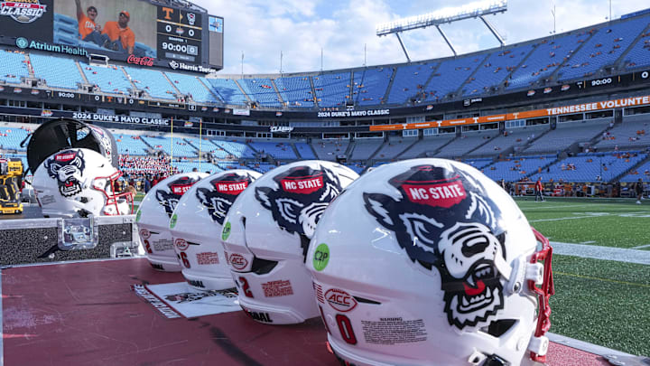 Sep 7, 2024; Charlotte, North Carolina, USA; North Carolina State Wolfpack helmets during pregame activity for the Dukes Mayo Classic against the Tennessee Volunteers at Bank of America Stadium. Mandatory Credit: Jim Dedmon-Imagn Images