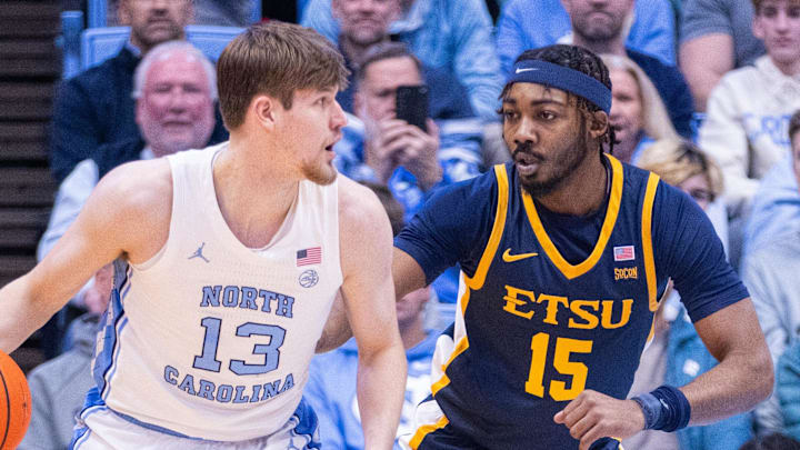 Dec 16, 2025; Chapel Hill, North Carolina, USA; North Carolina Tar Heels center Henri Veesaar (13) backs down ETSU Buccaneers forward Cam Morris III (15) during the first half at Dean E. Smith Center. Mandatory Credit: Scott Kinser-Imagn Images