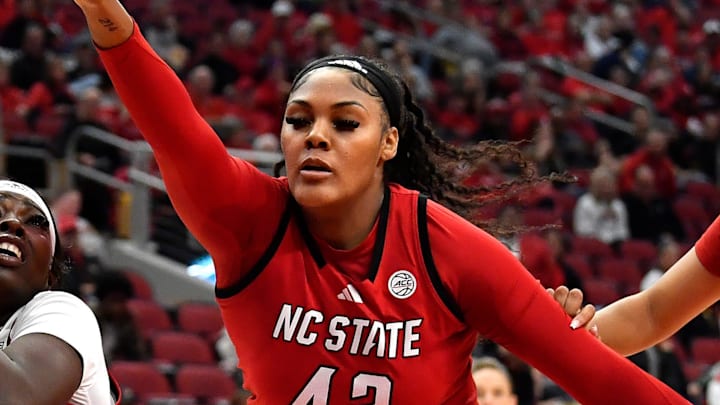 Louisville forward Olivia Cochran (44) looks for a shot over NC State center Mallory Collier (42) during the first half of an NCAA college basketball game, Sunday, Dec. 15, 2024, in Louisville, Ky.