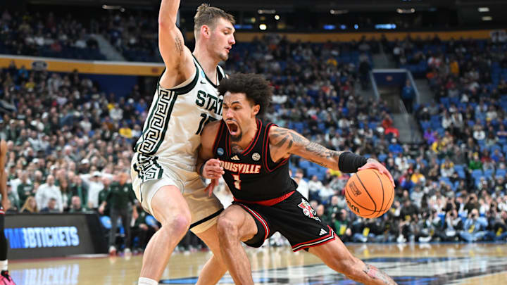 Mar 21, 2026; Buffalo, NY, USA; Louisville Cardinals guard J'Vonne Hadley (1) drives the ball in the second half against the Michigan State Spartans during a second round game of the men's 2026 NCAA Tournament at Keybank Center. Mandatory Credit: Mark Konezny-Imagn Images Mar 21, 2026; Buffalo, NY, USA; Louisville Cardinals guard J'Vonne Hadley (1) drives the ball in the second half against the Michigan State Spartans during a second round game of the men's 2026 NCAA Tournament at Keybank Center. Mandatory Credit: Mark Konezny-Imagn Images