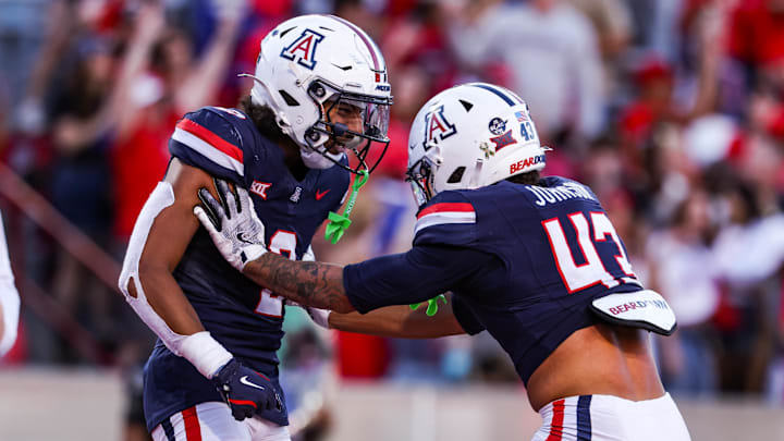 Nov 8, 2025; Tucson, Arizona, USA; Arizona Wildcats defensive backs Treydan Stukes and Dalton Johnson celebrate a win against the Kansas Jayhawks at the end of the game at Arizona Stadium. Mandatory Credit: Aryanna Frank-Imagn Images