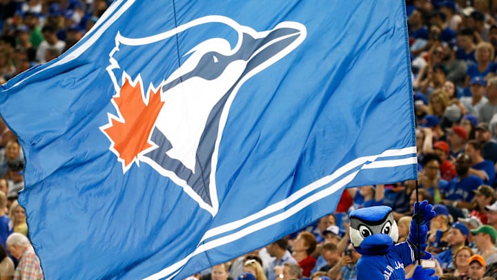 Toronto Blue Jays mascot Ace waves a Blue Jays flag