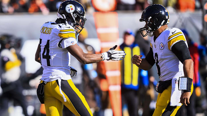 Pittsburgh Steelers wide receiver George Pickens reacts with quarterback Russell Wilson after scoring a touchdown.