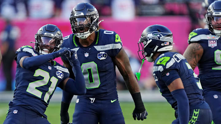 Feb 8, 2026; Santa Clara, CA, USA; Seattle Seahawks defensive end DeMarcus Lawrence (0) and Seattle Seahawks cornerback Devon Witherspoon (21) react after a play during the first quarter against the New England Patriots in Super Bowl LX at Levi's Stadium. 