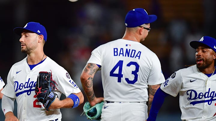 Los Angeles Dodgers catcher Will Smith (16) left fielder Michael Conforto (23) pitcher Anthony Banda (43) and outfielder Justin Dean (75) celebrate the victory against the Cincinnati Reds Dodger Stadium on Aug. 25. Los Angeles Dodgers catcher Will Smith (16) left fielder Michael Conforto (23) pitcher Anthony Banda (43) and outfielder Justin Dean (75) celebrate the victory against the Cincinnati Reds Dodger Stadium on Aug. 25.