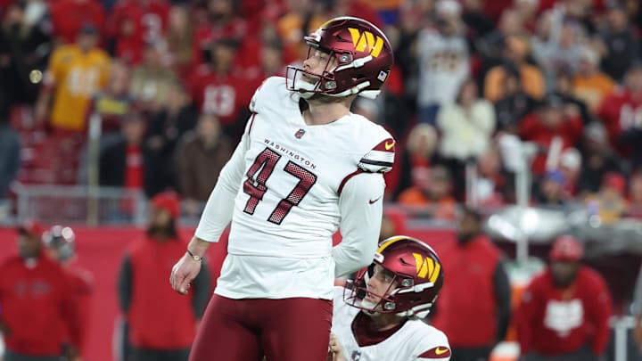 Jan 12, 2025; Tampa, Florida, USA; Washington Commanders place kicker Zane Gonzalez (47) kicks the game-winning field goal out of the hold of punter Tress Way (10) during the fourth quarter of a NFC wild card playoff against the Tampa Bay Buccaneers at Raymond James Stadium. Mandatory Credit: Kim Klement Neitzel-Imagn Images