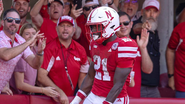 Nebraska Cornhusker fans celebrate with running back Emmett Johnson after a touchdown during the game against Michigan State at Memorial Stadium. Nebraska Cornhusker fans celebrate with running back Emmett Johnson after a touchdown during the game against Michigan State at Memorial Stadium.