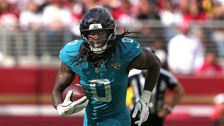 Sep 28, 2025; Santa Clara, California, USA; Jacksonville Jaguars linebacker Devin Lloyd (0) returns an interception against the San Francisco 49ers during the third quarter at Levi's Stadium. Mandatory Credit: Darren Yamashita-Imagn Images