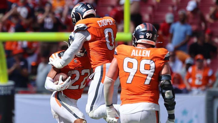 Sep 22, 2024; Tampa, Florida, USA; Denver Broncos safety Brandon Jones (22) celebrates with linebacker Jonathon Cooper (0) after he picked up a fumble recovery against the Tampa Bay Buccaneers during the second half at Raymond James Stadium. 