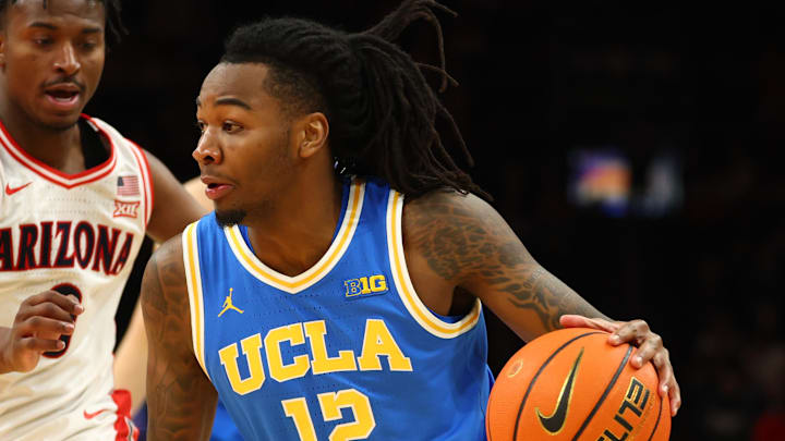Dec 14, 2024; Phoenix, Arizona, USA; UCLA Bruins guard Sebastian Mack (12) against Arizona Wildcats guard Jaden Bradley (0) at Footprint Center. Mandatory Credit: Mark J. Rebilas-Imagn Images