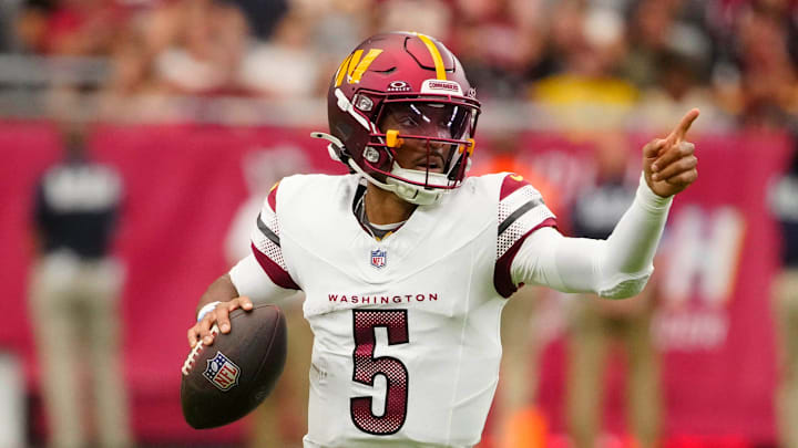 Commanders quarterback Jayden Daniels (5) looks for open receivers against the Cardinals during a game at State Farm Stadium in Glendale on Sept. 29, 2024.