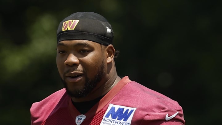 Washington Commanders defensive tackle Daron Payne stands on the field on day one of minicamp.