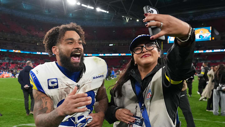 Oct 19, 2025; London, United Kingdom; Los Angeles Rams running back Kyren Williams (23) takes a video with social programing manager Patty Vicente after their win against the Jacksonville Jaguars in an NFL International Series game at Wembley Stadium. Mandatory Credit: Kirby Lee-Imagn Images