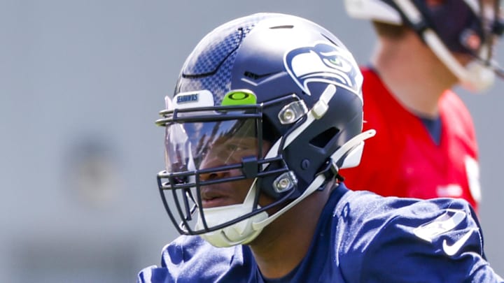 Seattle Seahawks running back Ken Walker III participates in a drill during an OTA workout. Seattle Seahawks running back Ken Walker III participates in a drill during an OTA workout.