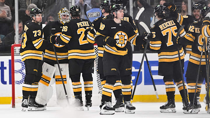 Mar 19, 2026; Boston, Massachusetts, USA; Boston Bruins goaltender Jeremy Swayman (1) celebrates defeating the Winnipeg Jets with defenseman Andrew Peeke (26) and defenseman Charlie McAvoy (73) at TD Garden. Mandatory Credit: Eric Canha-Imagn Images