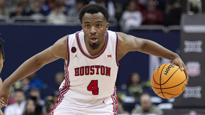 Houston Cougars guard LJ Cryer (4) controls the ball while defended by Texas Tech Red Raiders guard Chance McMillian (0)  in the second half at T-Mobile Center. 