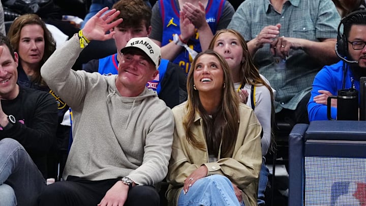 Apr 19, 2025; Denver, Colorado, USA; Denver Broncos quarterback Bo Nix (center) wave to the crowd in the first quarter against the LA Clippers at Ball Arena. Apr 19, 2025; Denver, Colorado, USA; Denver Broncos quarterback Bo Nix (center) wave to the crowd in the first quarter against the LA Clippers at Ball Arena.