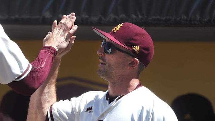 ASU's Spencer Torkelson (20) high-fives hitting coach Michael Earley after Torkelson scored against Arizona during a game at Phoenix Municipal Stadium in Phoenix, Ariz. on March 30, 2019.

Z6i9069