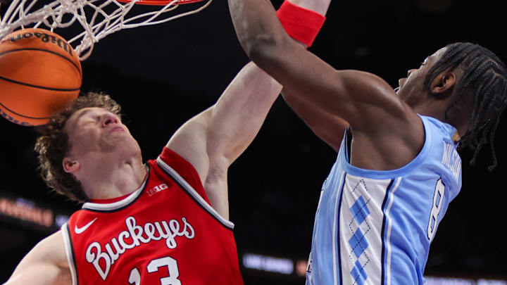 Dec 20, 2025; Atlanta, Georgia, USA; North Carolina Tar Heels forward Caleb Wilson (8) dunks over Ohio State Buckeyes center Christoph Tilly (13) in the second half at State Farm Arena. Mandatory Credit: Brett Davis-Imagn Images
