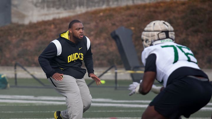 New Offensive Line coach A'lique Terry, center, runs a drill during the first practice of spring for Oregon Football Thursday March 16, 2023.