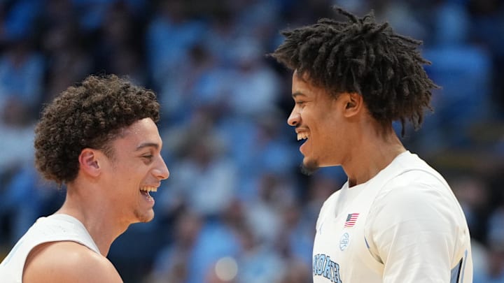 Feb 2, 2026; Chapel Hill, North Carolina, USA;  North Carolina Tar Heels guard Kyan Evans (0) and forward Jonathan Powell (11) react in the first half at Dean E. Smith Center. Mandatory Credit: Bob Donnan-Imagn Images