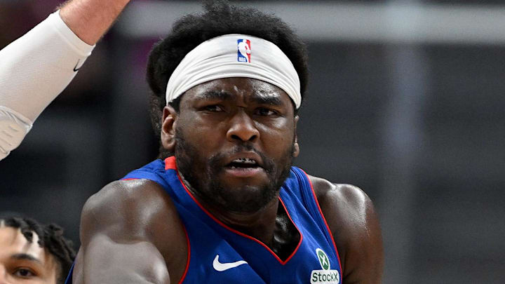 Feb 3, 2026; Detroit, Michigan, USA;  Detroit Pistons forward Isaiah Stewart (28) passes the ball to teammate Cade Cunningham (2) while being defended by Denver Nuggets center Jonas Valanciunas (17) in the fourth quarter at Little Caesars Arena. Mandatory Credit: Lon Horwedel-Imagn Images