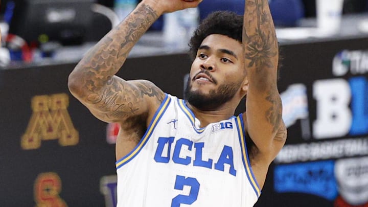 Mar 14, 2026; Chicago, IL, USA; UCLA Bruins guard Donovan Dent (2) shoots against Purdue Boilermakers forward Trey Kaufman-Renn (4) during the first half at United Center. Mandatory Credit: Kamil Krzaczynski-Imagn Images