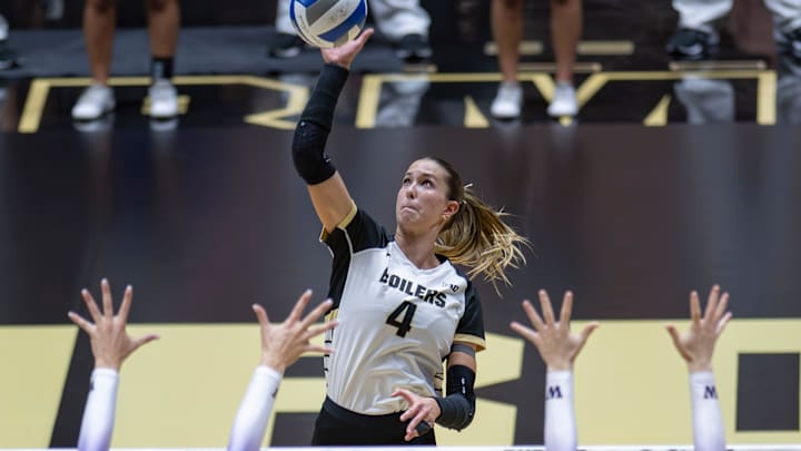 Purdue Junior Kenna Wollard (4) floats the ball over blockers 
